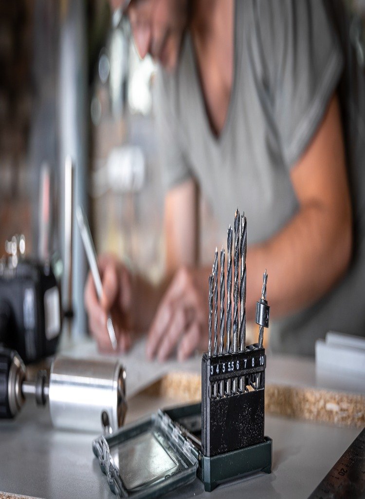 Electroplating technician working on metal parts in a Chicago-based plating facility
